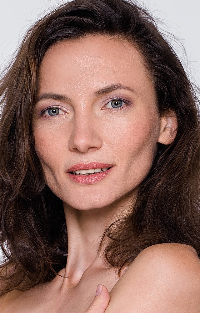Portrait of a woman with wavy brown hair.