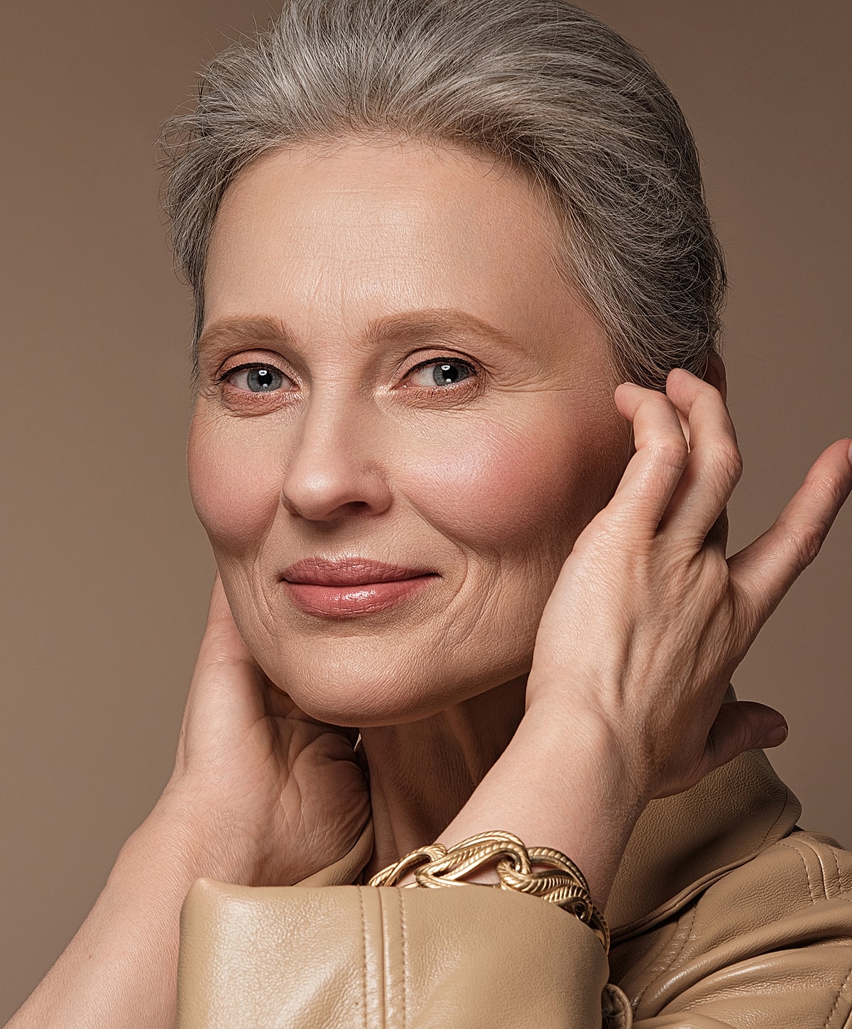 Portrait of a smiling older woman with gray hair.