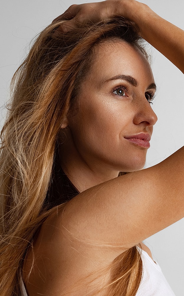 Woman with long hair posing confidently.