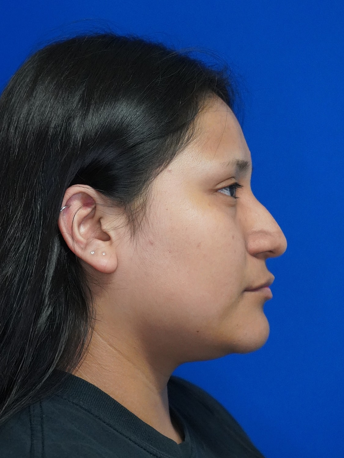 Profile portrait of a person with dark hair.