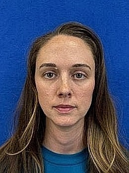 Portrait of a woman against blue background.