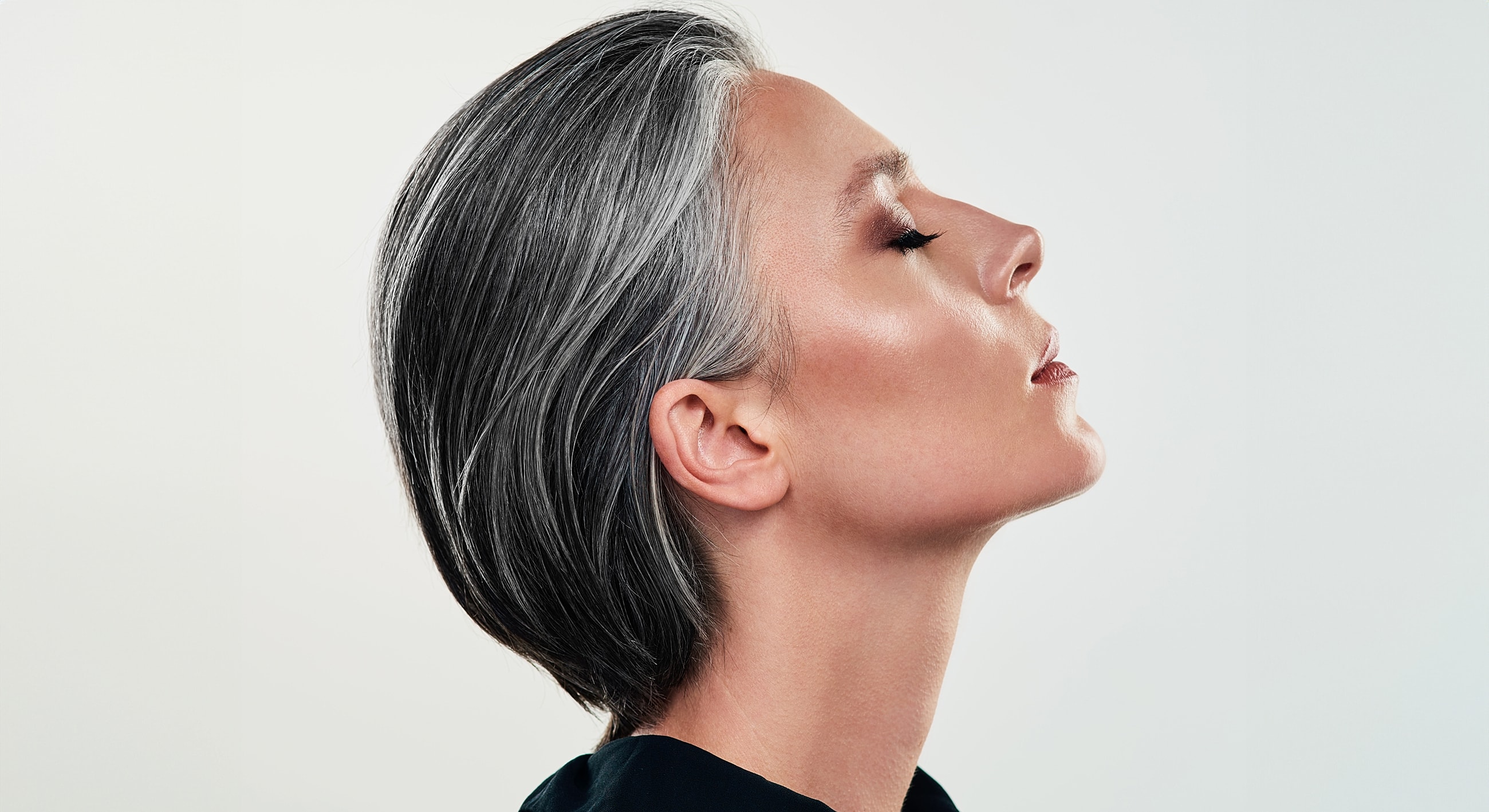 Profile of a woman with gray hair.